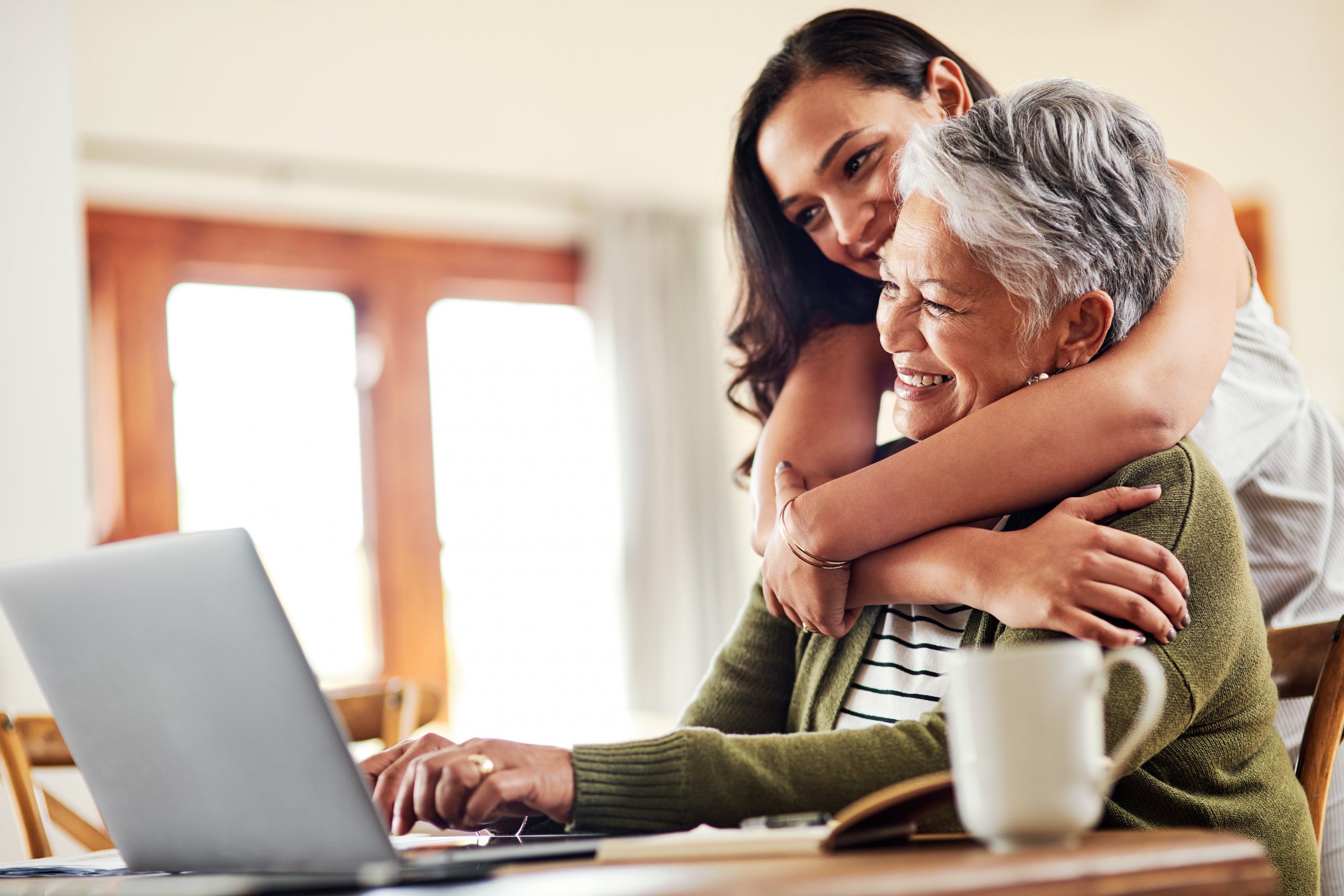 Cropped shot of an attractive young woman hugging her grandmother